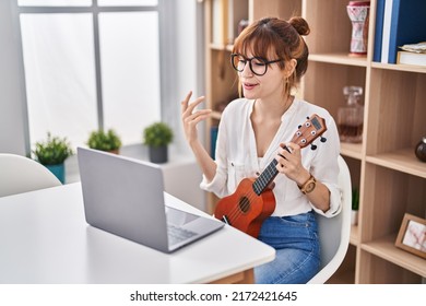 Young Woman Having Online Ukelele Class At Home