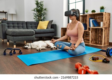 Young Woman Having Online Yoga Class Using Vr Goggles At Home