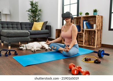 Young Woman Having Online Yoga Class Using Vr Goggles At Home