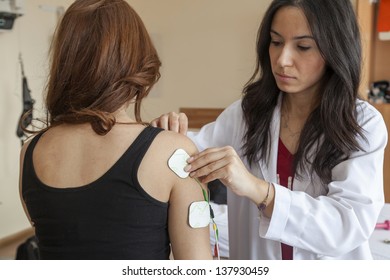 Young Woman Having A Physical Therapy Session With Electrodes