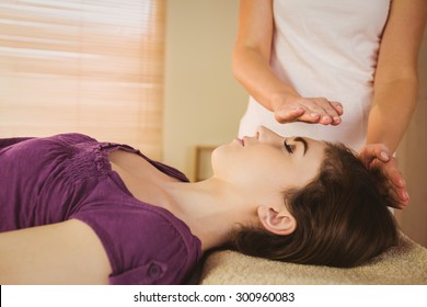Young Woman Having A Reiki Treatment In Therapy Room