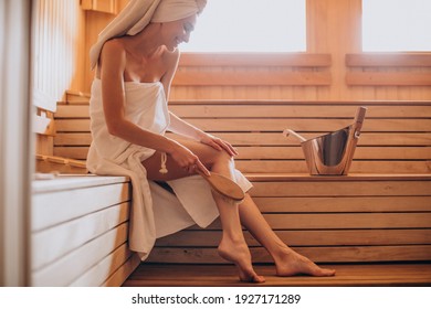 Young woman having rest in sauna alone
