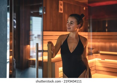 A young woman having rest in sauna alone.