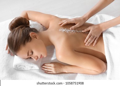 Young Woman Having Salt Massage In Spa Salon