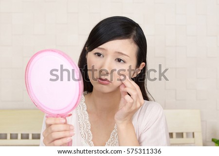 Young woman having skin problems