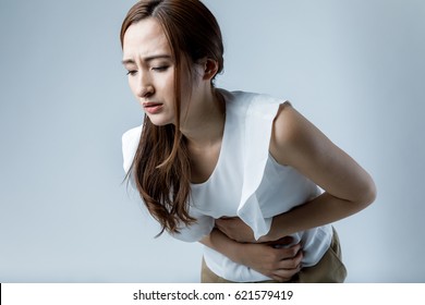 young woman having a stomachache - Shutterstock ID 621579419