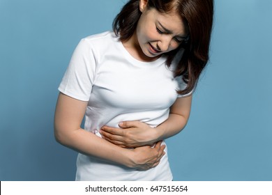 young woman having a stomachache - Shutterstock ID 647515654