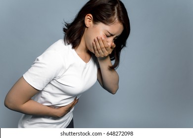 Young woman having a stomachache and being going to vomit.