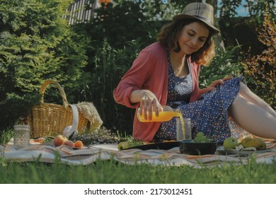 Young Woman Having Summer Picnic Eating Outside. Summer Outdoors Activities. Backyard Picnic.