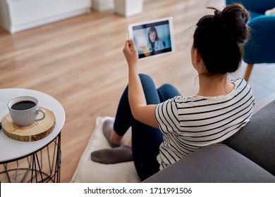 Young Woman Having A Video Conference With Her Doctor