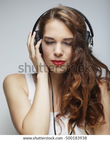 Similar – Blonde woman listening to music with her headphones