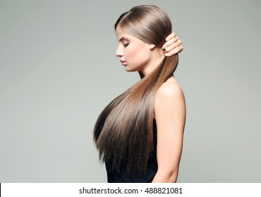 Young Woman With Healthy Hair On Color Background