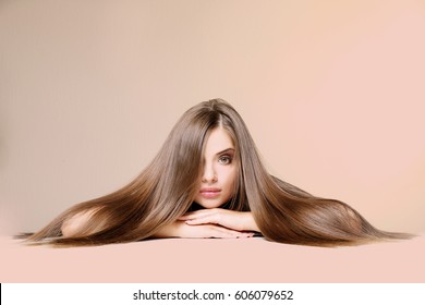 Young Woman With Healthy Hair On Color Background