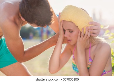 Young Woman With Heatstroke On A Beach