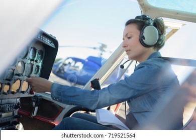 young woman helicopter pilot - Shutterstock ID 719521564