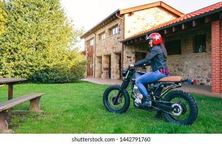 Young woman with helmet riding a custom motorbike outdoors - Powered by Shutterstock