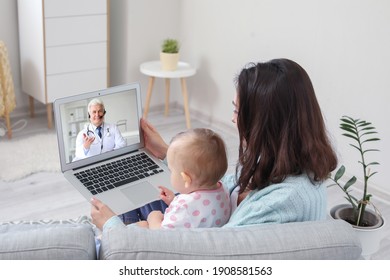 Young woman with her baby getting online consultation at home