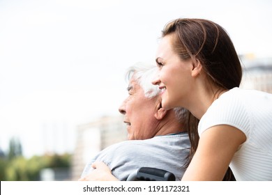 Young Woman With Her Disabled Father Near Railing At Outdoors - Powered by Shutterstock