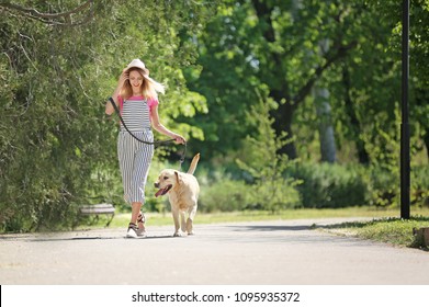 Young Woman And Her Dog Spending Time Together Outdoors. Pet Care