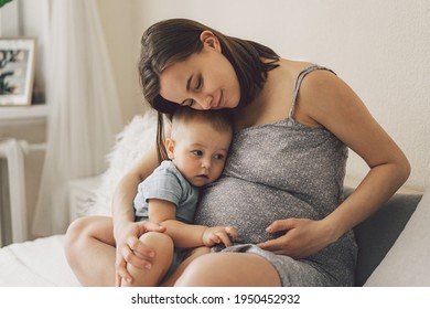 Young woman with her first child during second pregnancy. Motherhood and parenting concept. Toddler boy and mom. Happy family expecting for baby.  - Powered by Shutterstock