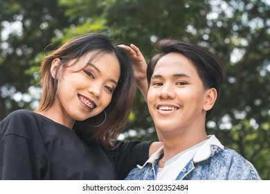 A Young Woman And Her Gay Best Friend Smile For The Camera. A Strong Friendship.