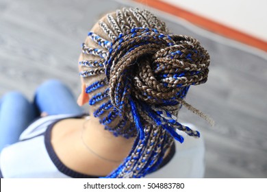 A Young Woman, Her Hair Braided In Pigtails Thin Blue