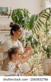 Young woman with her little daughter is watering houseplants at home and having fun splashing water.Home gardening.Family leisure,hobby concept.Biophilia design and urban jungle concept. - Shutterstock ID 2065832786
