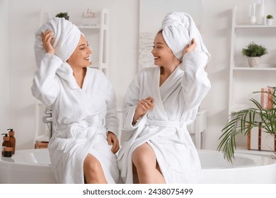 Young woman with her mother after shower in bathroom - Powered by Shutterstock