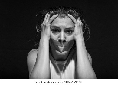 A Young Woman With Her Mouth Taped Shut. Close-up Portrait.
