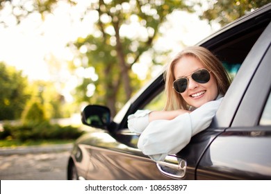 Young Woman In Her New Car Smiling.