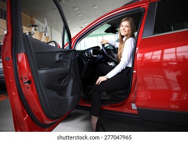 Young Woman In Her New Car Smiling