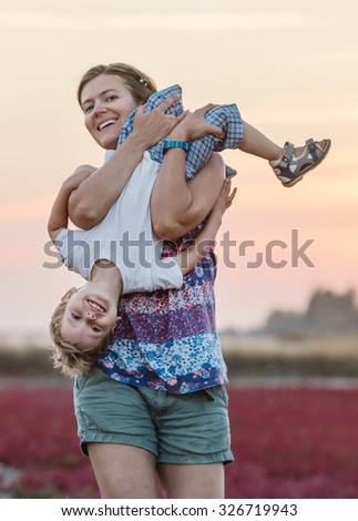 Young woman and her son having fun outdoors