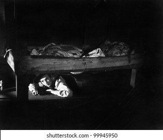 Young Woman Hiding Under The Bed