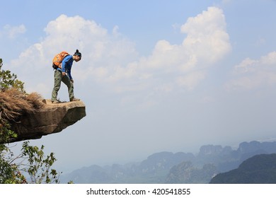 Young Woman Hiker Enjoy The View At Mountain Peak Cliff