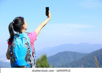 Young Woman Hiker Use Smart Phone Taking Self Photo At Mountain Peak 