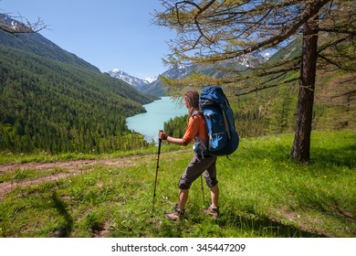 Young Woman Is Hiking In Highlands Of Altai Mountains, Russia