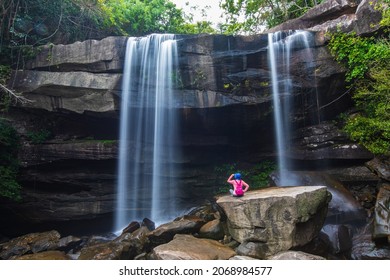 Young woman hiking in Thung Na Muang Waterfall, Beautiful waterfall in Pha Tam national Park, Ubon Ratchathani  province, ThaiLand. - Shutterstock ID 2068984577