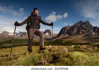 Young woman hiking (trekking) in spectacular high mountains, Patagonia, Chile