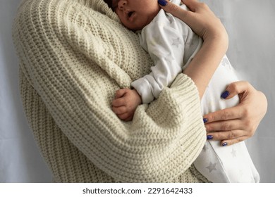 young woman hold baby in hands, mother and child, hands close up - Powered by Shutterstock