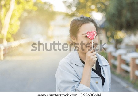 Young woman hold lollipop on face.concept valentine day