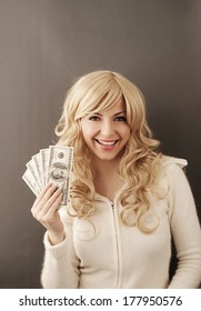 Young woman holding 500 dollars 
