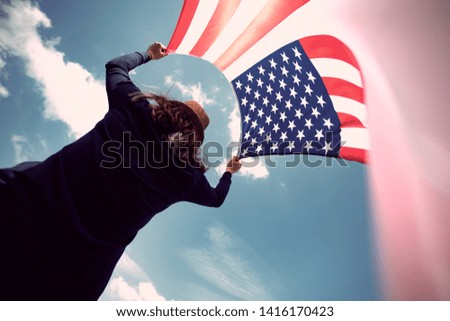 Young woman holding american USA flag. Independence Day or traveling in America concept. 