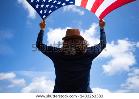 Young woman holding american USA flag. Independence Day or traveling in America concept.