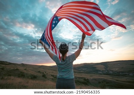 Young woman holding american USA flag. Independence Day or traveling in America concept. 
