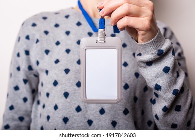 Young Woman Holding Badge, Name Tag Close Up On Light Hill Background 