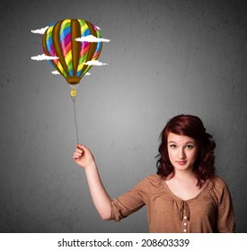 Young woman holding balloon