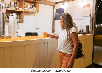 Young Woman Holding Beer In The Bar Of Food Truck