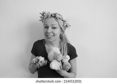 Young Woman Holding Big Group Of Plush Hens Or Chicken. Celebrating Easter Holidays In 2022. Spring Symbol And Decoration. Girl Wearing Flower Wreath On Head Made Out Of Forsythia And Cherry Flowers.