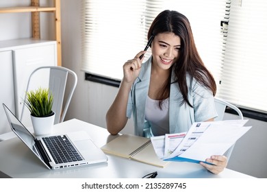Young woman holding bill with smile happily after no debt. Not worried about the problems caused by credit card debt. - Shutterstock ID 2135289745