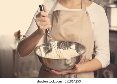 Young Woman Holding Bowl With Dough And Whisk, Closeup